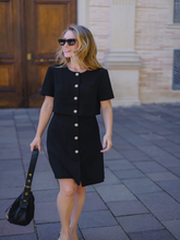 A woman wears a triacetate dress